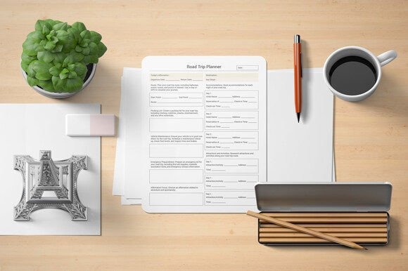 Trip planner template showing a detailed road trip planner sheet on a desk with office supplies and a cup of coffee